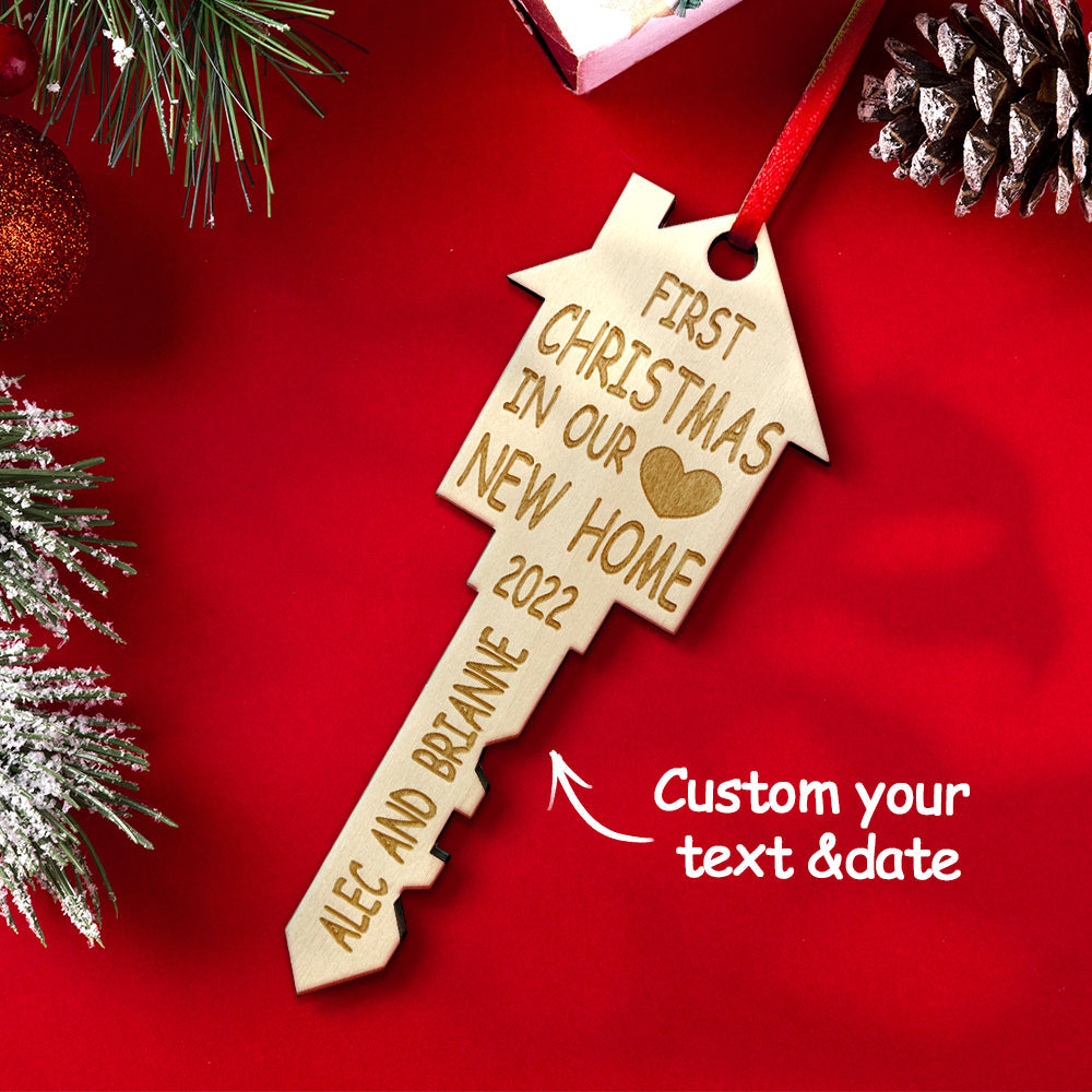 Personalized wooden key-shaped Christmas ornament reading 'First Christmas in Our New Home', perfect housewarming gift.